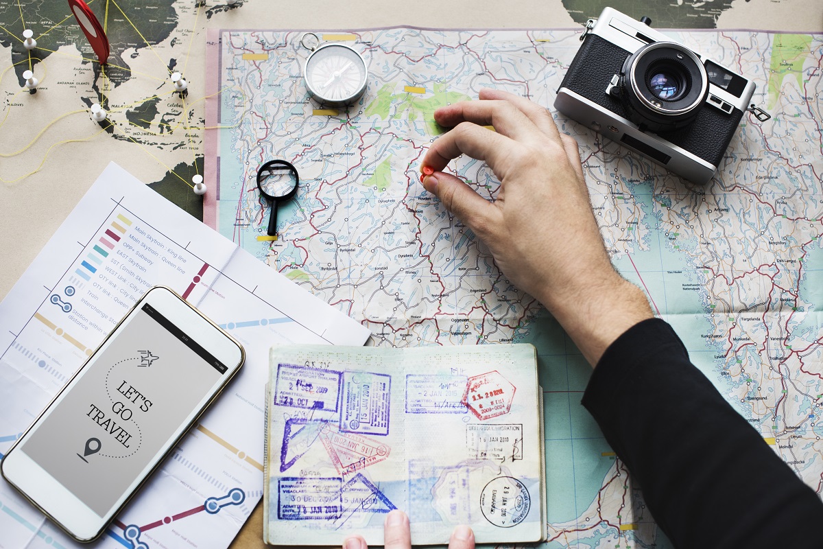 Aerial view of hand pinning on world map journey travel