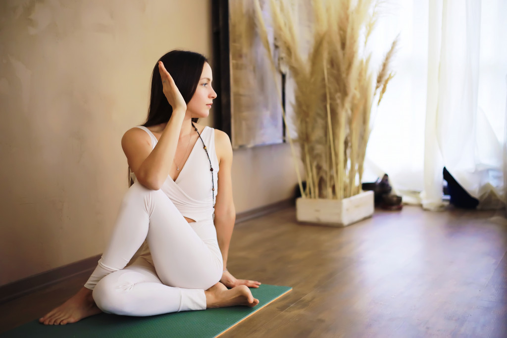 Beautiful athletic girl doing yoga exercises enjoy meditation at home. No stress, healthy habit, anxiety relief concept. Lotus.