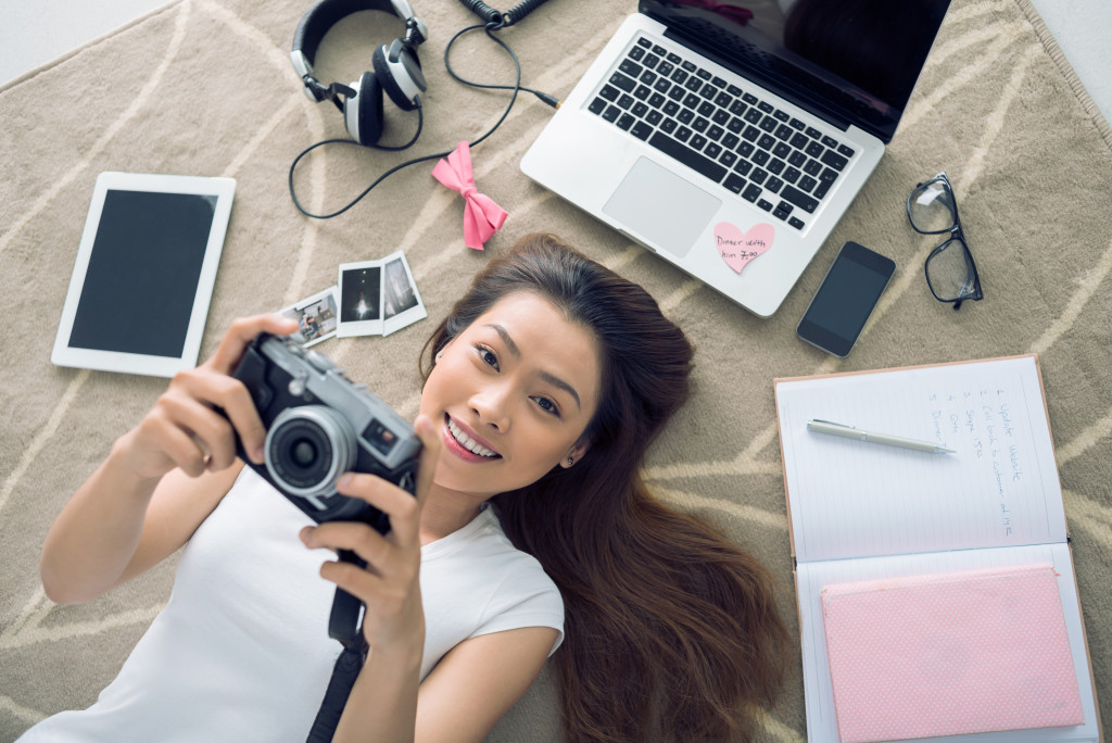 holding a camera with other tools