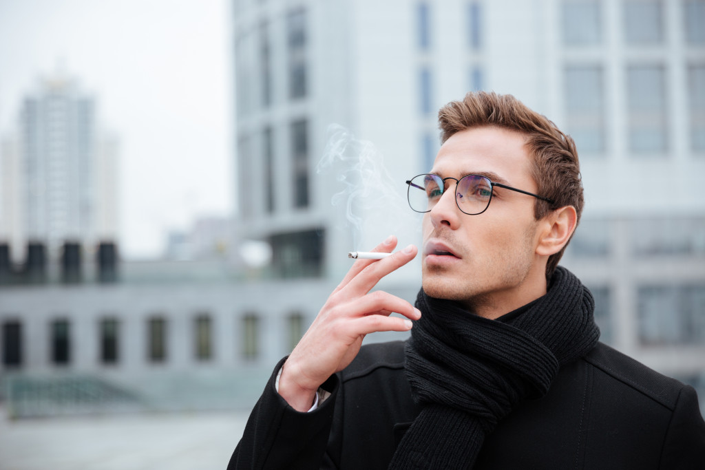 man in busiess wear smoking outdoor