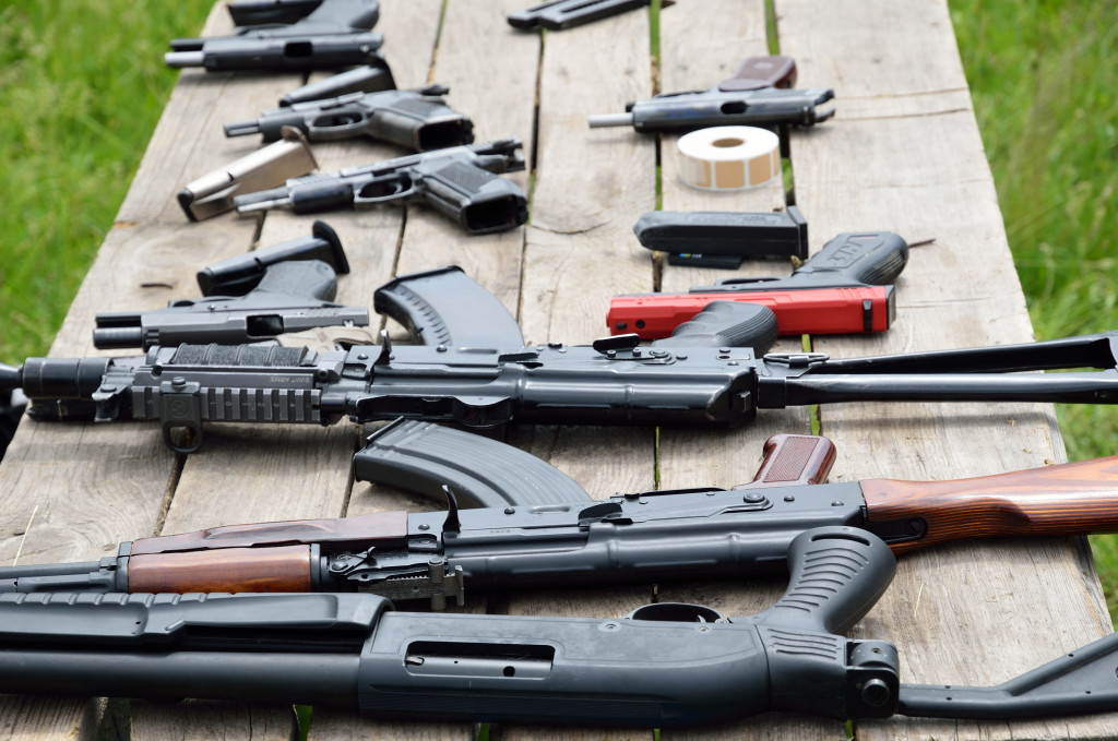 Different types of firearms displayed on a table