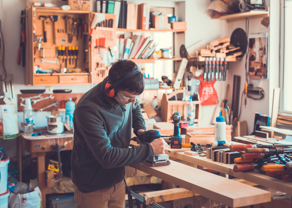 man creating wood furniture