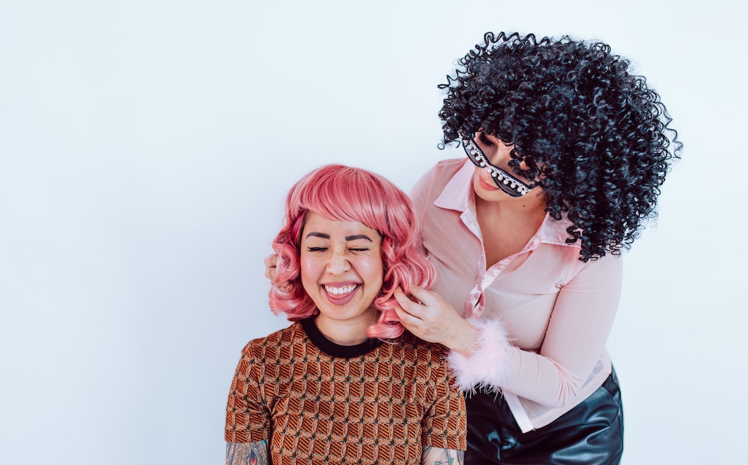 A Woman Touching Another Person's Hair