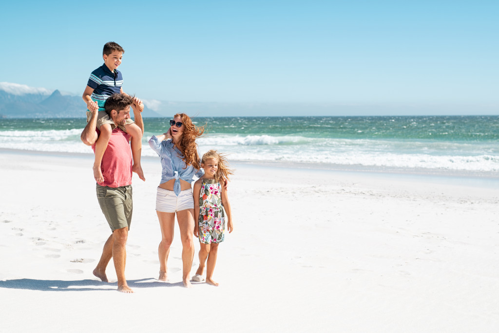 family walking at the shore of the beach