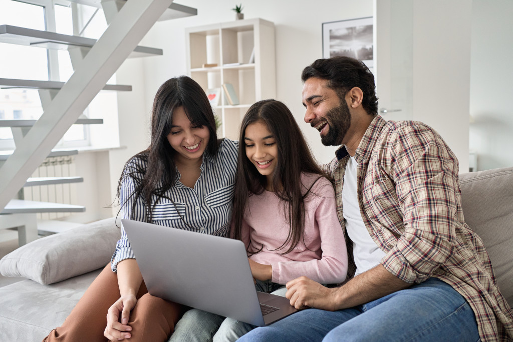 happy family in the couch using laptop