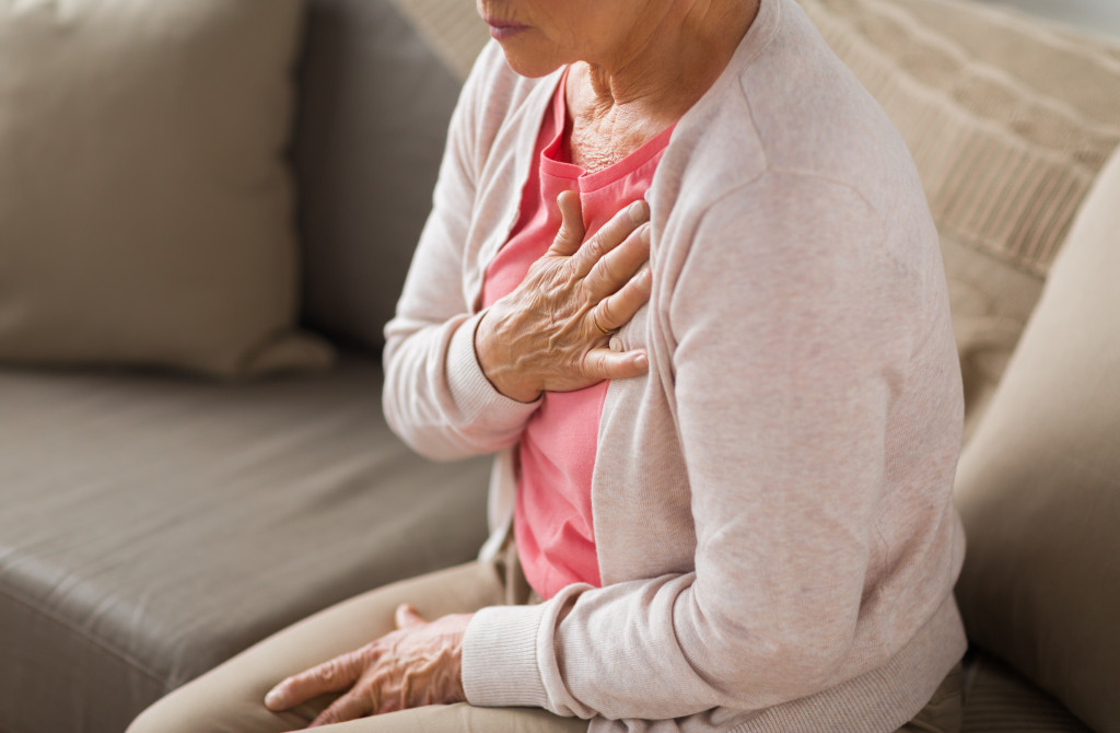 Woman with heart disease sitting on sofa
