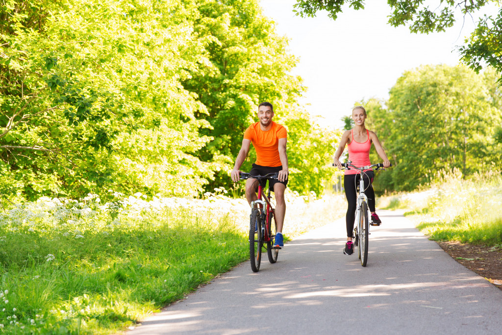 a man and a woman doing a bike