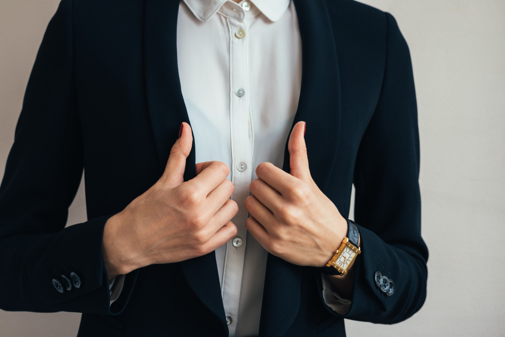 female professional putting on suit in a business attire