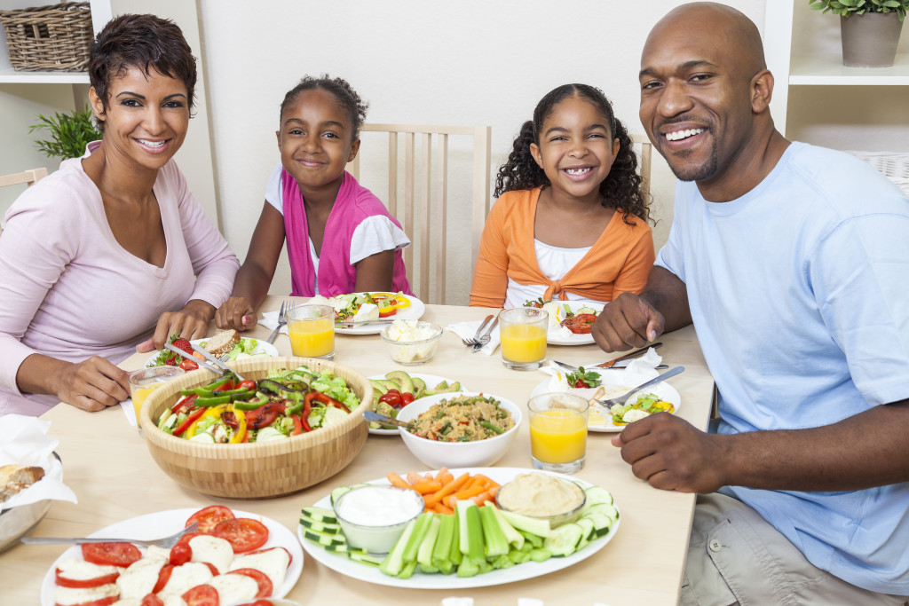 Family eating fruits and vegetables for lunch at home.