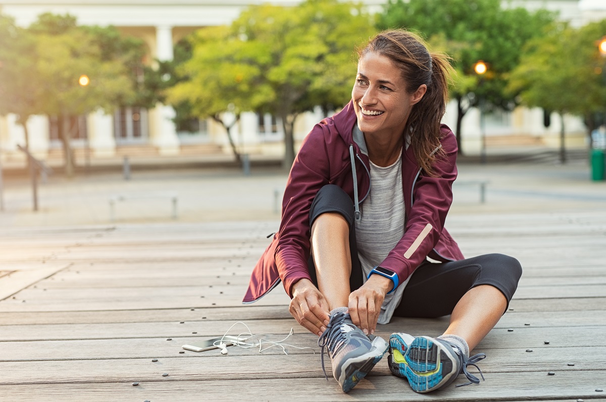 runner sitting on floor on city streets