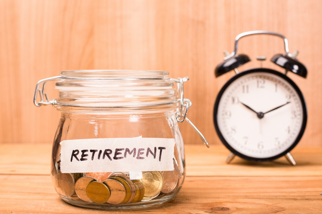 Coins in a jar labeled with the word RETIREMENT